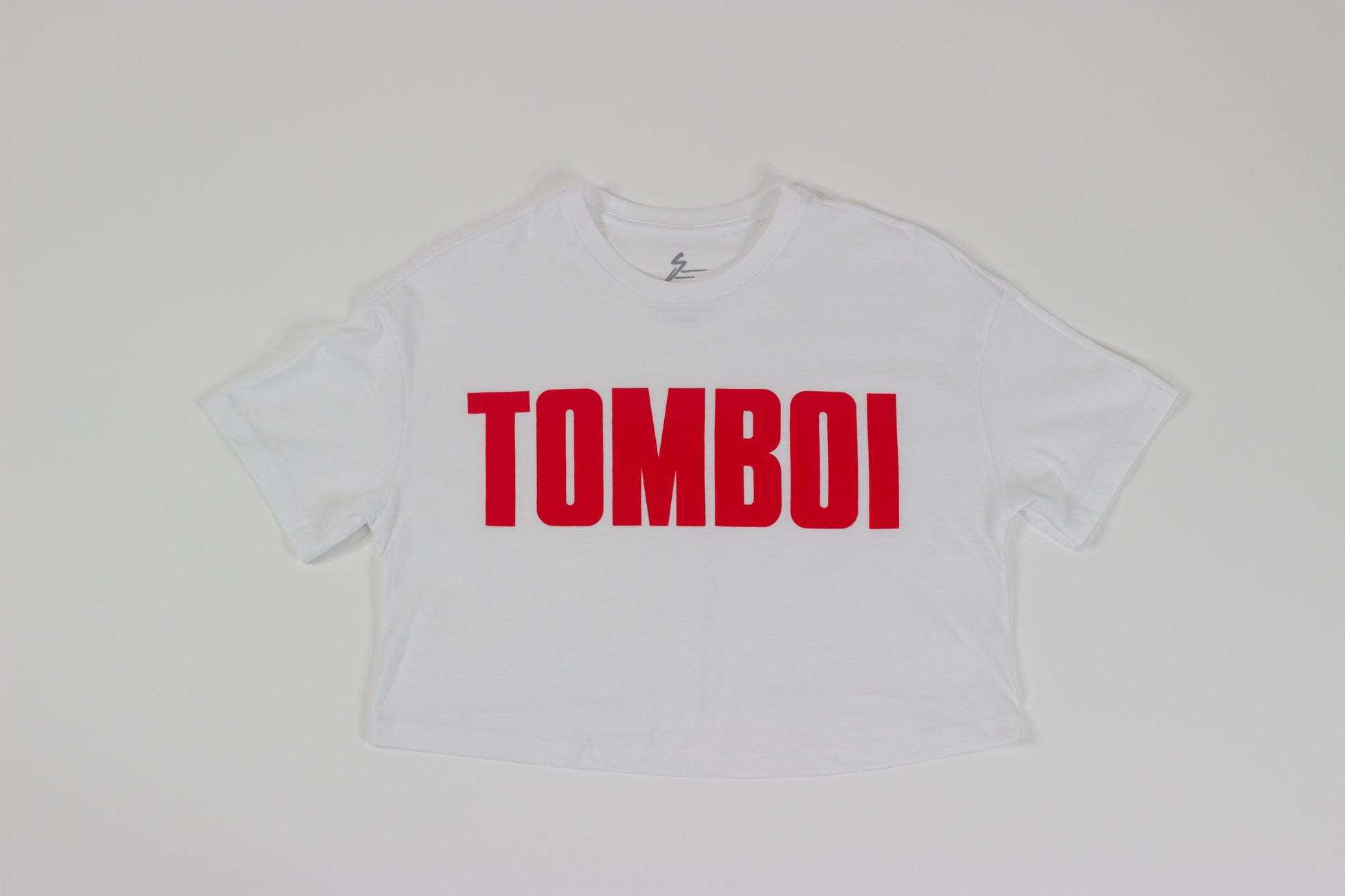 white TOMBOI crop top with red writing